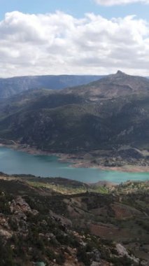 Drone view of the dam surrounded by high slopes, artificial irrigation dam in the middle of the large land, view of Ermenek dam in Turkey