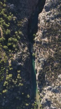 Drone view of the valley between the mountains, the wonder of natural formation with a stream passing through it
