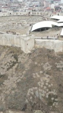 Drone view of the ancient castle in the middle of the city, Gaziantep castle surrounded by buildings, defense castle built on a small hill in Turkey