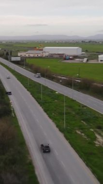 Drone view of roads passing through green fields, TRNC magosa highway view, main road traffic passing through residential areas