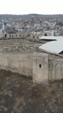 Drone view of the historical castle made of stone in Gaziantep, very large Turkish castle with castle walls and towers, historical castle built on a hill