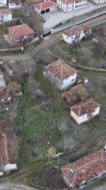 Aerial drone view of small village, small population tile roofed houses, rural life village houses roofs, settlement in rural village in autumn