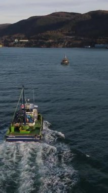 Drone view of boats advancing to fish in the sea, fishing boats on the lake, fishing season, hunting with seanets