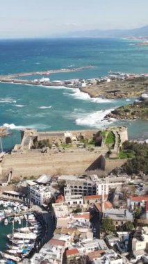 The beauty of the city of Kyrenia built by the sea, the drone view of the marina and the settlement of the city, the city of Kyrenia located between the mountain and the sea