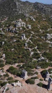 Simena 'nın antik harabelerinin drone görüntüsü, dağın tepesindeki gözetleme kulesi, taşlardan yapılmış antik kalıntılar.