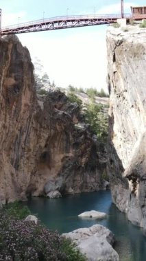 Drone view of the stream passing through the hard rocks, view of the Yerkopru national park canyon, the view of the waterfall flowing through the gray cliffs