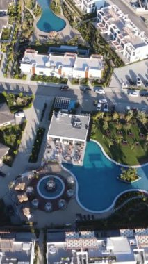 Drone view of holiday site in cyprus, water pools and entertainment venues and hotels for summer vacation near by the sea in cyprus