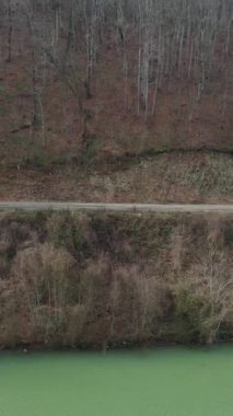 The images of dam lake waters accumulated in the valley in the forest, drone view of the hydroelectric power plant lake, dam lake surrounded by green forests