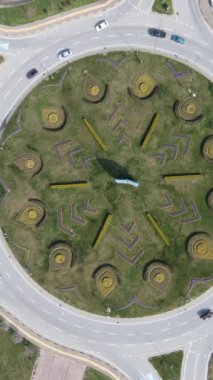 Traffic view of the vehicles in the roundabout island, the progress of the vehicles on the roads with intersections taken with a drone from the air