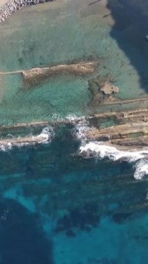 Drone view of the holiday site between the sea and the green, swimming pool and water parks and holiday places of cyprus, white holiday site next to the sea