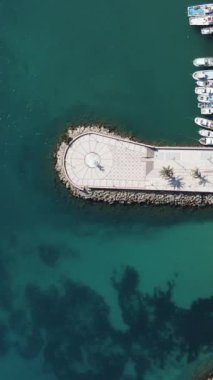 Aerial drone view of the harbor of the city of Aydincik, the areas that spend time by the beach in the marina, the aerial view of the city harbor