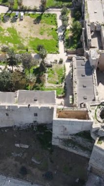 Inside the walls of the historical castle built by the sea, Kyrenia castle taken by drone from the air, Girne protected by the castle walls