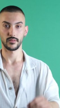 Handsome man wearing glasses, cool man wearing sunglasses, young man in white shirt wearing sunglasses to stay fashionable, isolated image of the model in front of the green screen