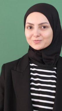 Yeşil Arkaplan Yapan Kız, Müslüman Kadın Tamam, Genç adam Yeşil Ekran 'ın önünde işaret parmağı imzalıyor, Kız jestler gülümsemesi