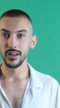 Man doing wow gesture, male model with gaping expression of surprise, facial expressions image taken portrait in front of green screen