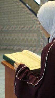 Kuran 'ı bir Kuran' da okumak, camide peçeli bir Müslüman 'ın duası, tesettürde Kuran okuyan bir kız, İslam ibadeti.