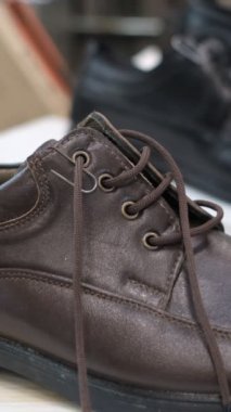 Man shoe shopping close-up, looking at and trying on shoes in the shopping store, image of choosing and buying shoes
