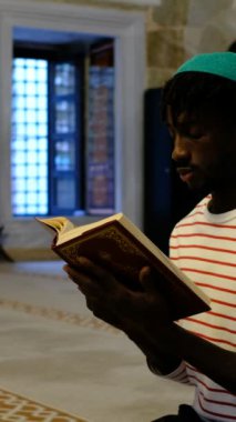 Afrikalı siyahi gençler camide oturmuş Kuran okuyorlar. Müslüman insanlar Allah 'a inanıyorlar.
