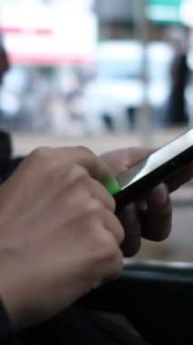 Telefon kullanan kadın eli görüntüsü, yakın çekim ekranı kaydırma, dışarıda sosyal medyada zaman geçirme