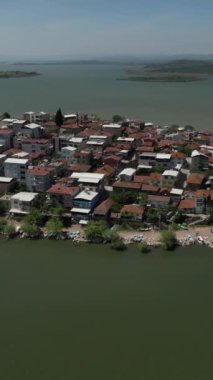 Aerial view of the golyazi, historical bursa golyazi drone image, living area built into the lake, touristic resorts of turkey, summer holiday destinations with different construction