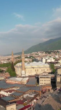 Aerial grand mosque of bursa, bursa great mosque square and its surroundings drone view, urban settlement with historical buildings