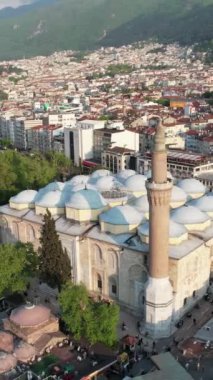 Historical Ottoman Mosque, drone image of inner city settlement of historical ottoman mosque, Bursa mosque famous for its minaret and domes