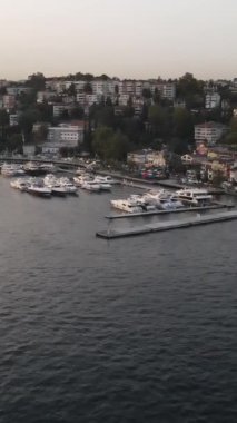 Yat İHA 'sının havadan görüntüsü rıhtım havzası küçük tekne, küçük bir körfeze yapılmış evler, marinanın üst manzarası.