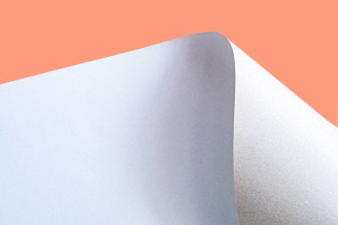 Large sheet of cardboard on an orange background.