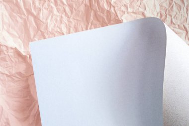 A sheet of cardboard on a background of crumpled paper.