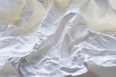 Heavily crumpled white paper as a background. 