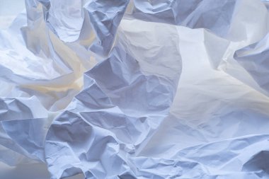 Heavily crumpled white paper as a background. 