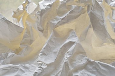 Heavily crumpled white paper as a background. 