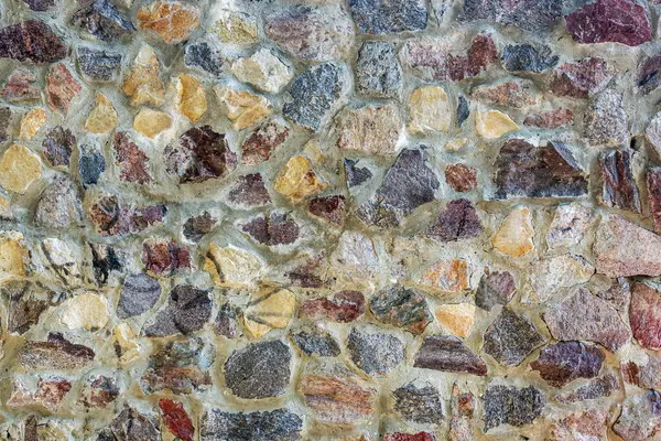 stock image A wall of colored granite stones as a background.