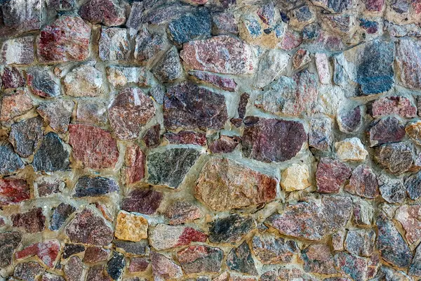 stock image A wall of colored granite stones as a background.