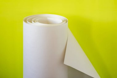 Sarı arka planda büyük rulo kağıtlar..
