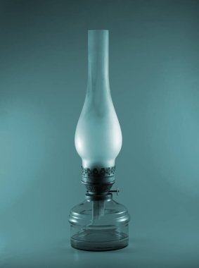 Eski bir gaz lambası cam bir ampulde serin bir renk şemasında.