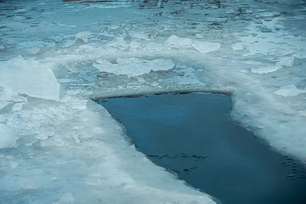 Kışın yüzmek için nehirde bir buz deliği.