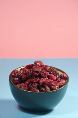 Vertical photography of dehydrated red blueberries.