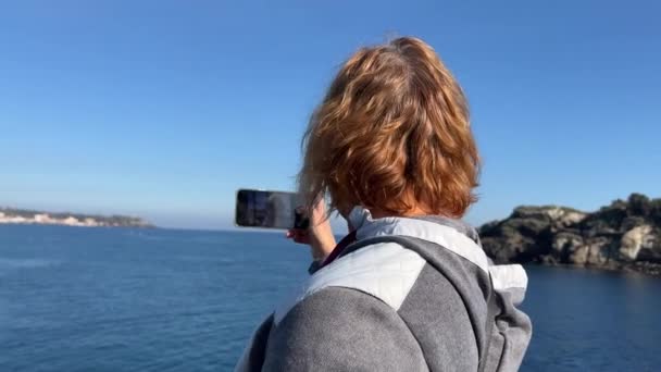 Tourist Woman Takes Pictures Smartphone Sea Volcano Woman Looking Sea — Stockvideo