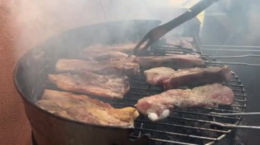 4K, BBQ with ribs pork, sausage, meatballs, grill in the garden of a house. Chef cooking barbecue with delicious grilled meat.