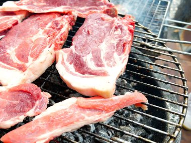 BBQ with ribs pork, sausage, meatballs, grill in the garden of a house. Chef cooking barbecue with delicious grilled meat