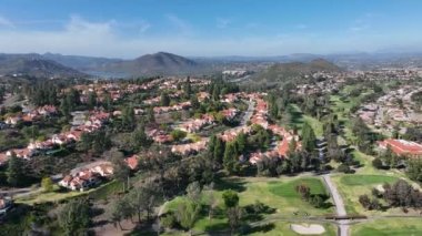 Aerial view of upscale residential neighborhood with green golf in South California. USA. 