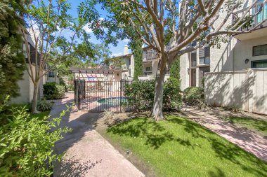 Beton yolu olan apartmanlar ve Carlsbad, San Diego, ABD 'de ağaçları olan bahçeler. 26 Haziran 2025