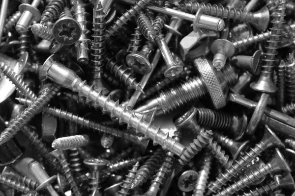 Hardware Sheet Metal  Head Screws Pile. Set of screws. Construction abstraction. Industrial background. Screws macro photo, screw background, steel screw, screw macro.