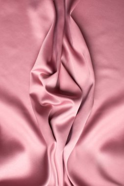 Pink soft fabric shaped as female genital organs, vulva and labia, vagina concept. High quality photo