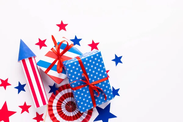 4th of July American Independence Day. Happy Independence Day. Red, blue and white star confetti, paper decorations on white background. Flat lay, top view, copy space, banner. High quality photo