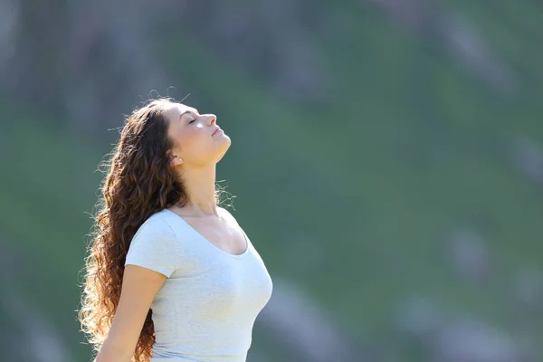 在阳光明媚的一天 一个女人在山上呼吸新鲜空气的侧景画像 — 图库照片