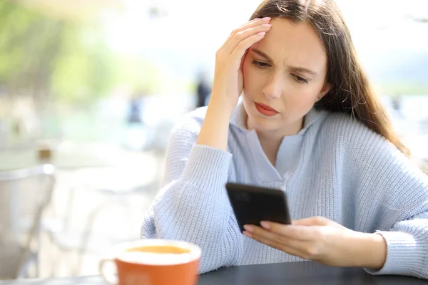 Worried Woman Checking Phone Sitting Restaurant Terrace Sunny Day — Stock Photo, Image