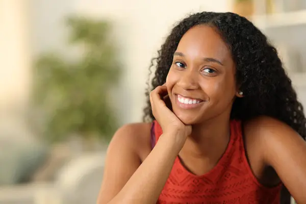 Beautiful black woman smiling at camera posing at home
