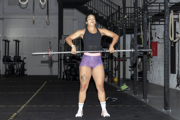 woman lifting weights in a gym